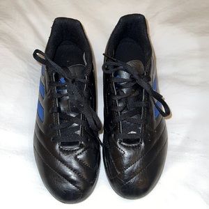 Black Adidas cleats with blue stripes.